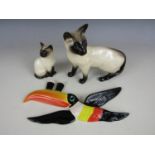 A Beswick cat figurine together with one other similar Royal Doulton figurine and a Guinness