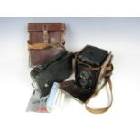 A vintage Rolleiflex camera together with a Cine-Kodak Eight Model 20 camera with case and