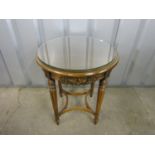 A contemporary mahogany carved occasional table with glass top