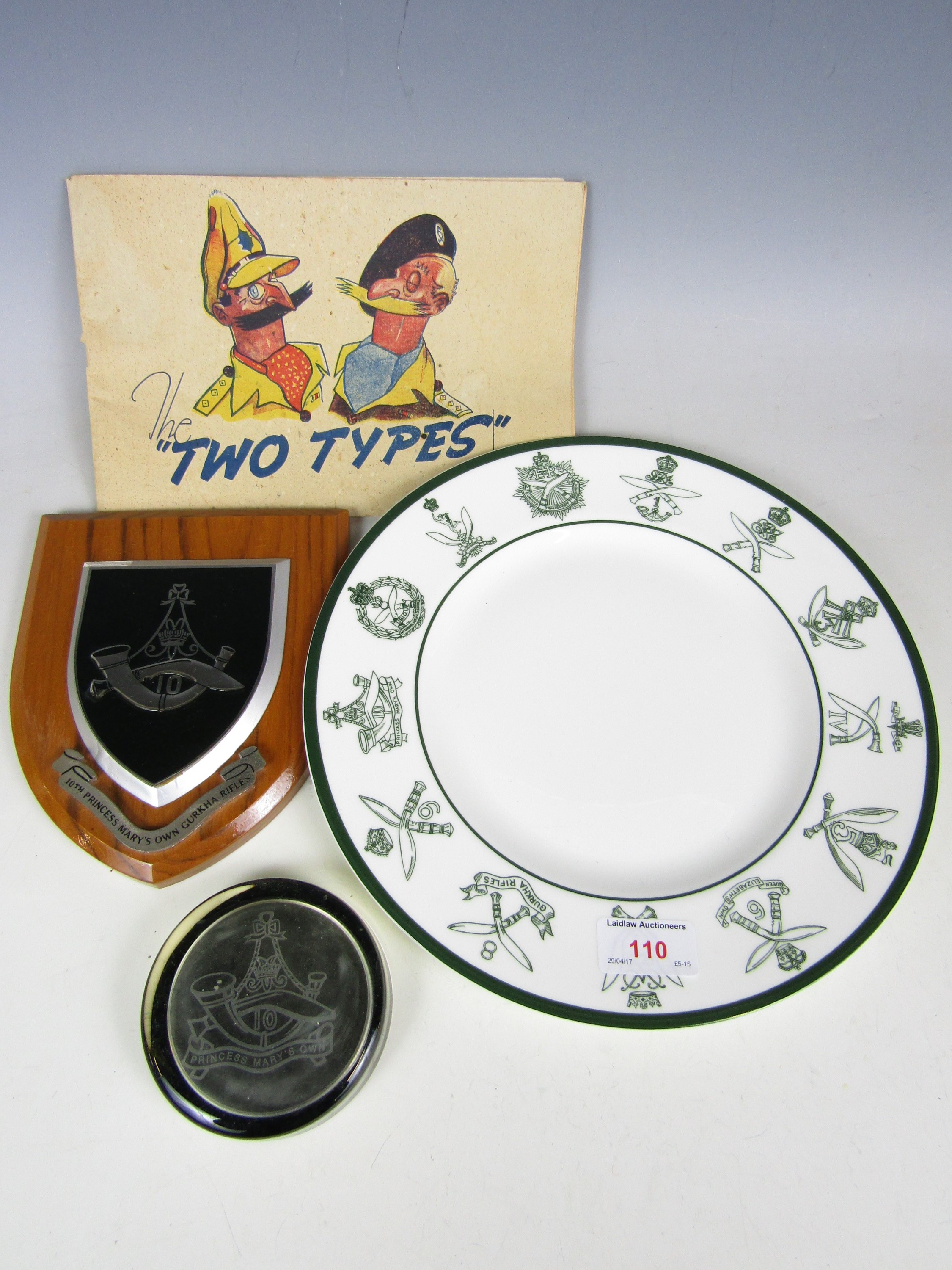 A Coalport Ghurka plate together with a plaque, a paperweight and a cartoon book The Two Types by