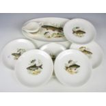 Six Crown Devon fish plates together with a serving plate and a sauce boat