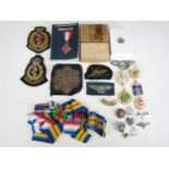 A quantity of military badges and insignia etc, including a GQ Parachutist badge