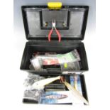 A small tackle box including sea fishing jigs etc