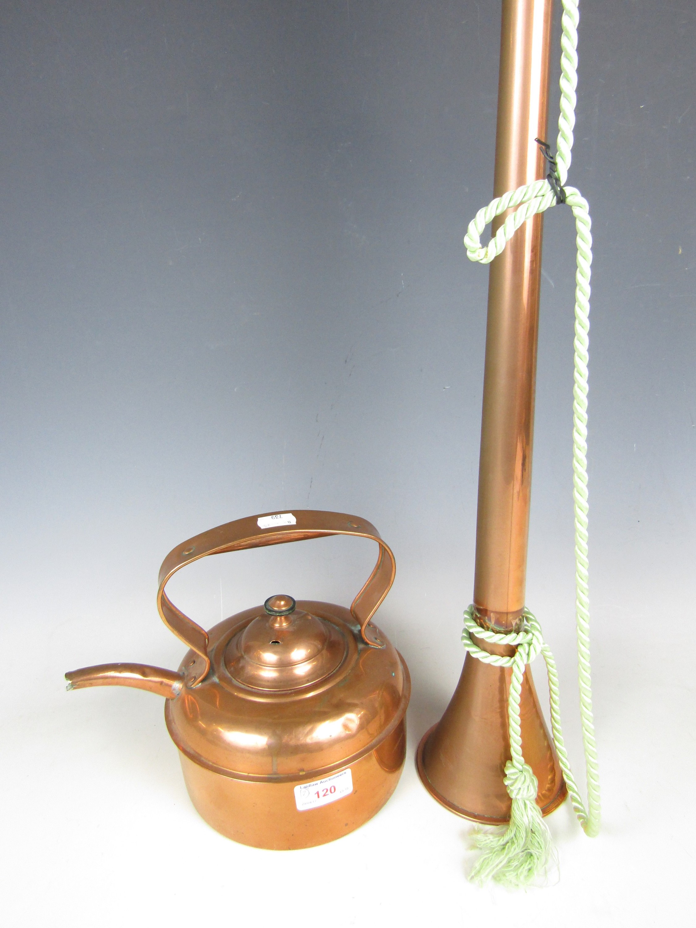 A copper hunting horn together with a copper kettle