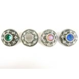 Four silver boss form brooches centrally set with paste stones (one a/f)