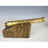 A model brass cannon on oak sled, the barrel 21 cm