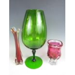 A large green glass goblet together with two studio glass vases