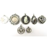 Seven silver and white metal pendants, including a Wedgwood plaque, a horoscope pendant, and a