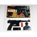 A vintage boxed Chad Valley Mauser 5 toy gun and accessories