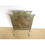 A 1930s planished brass firescreen