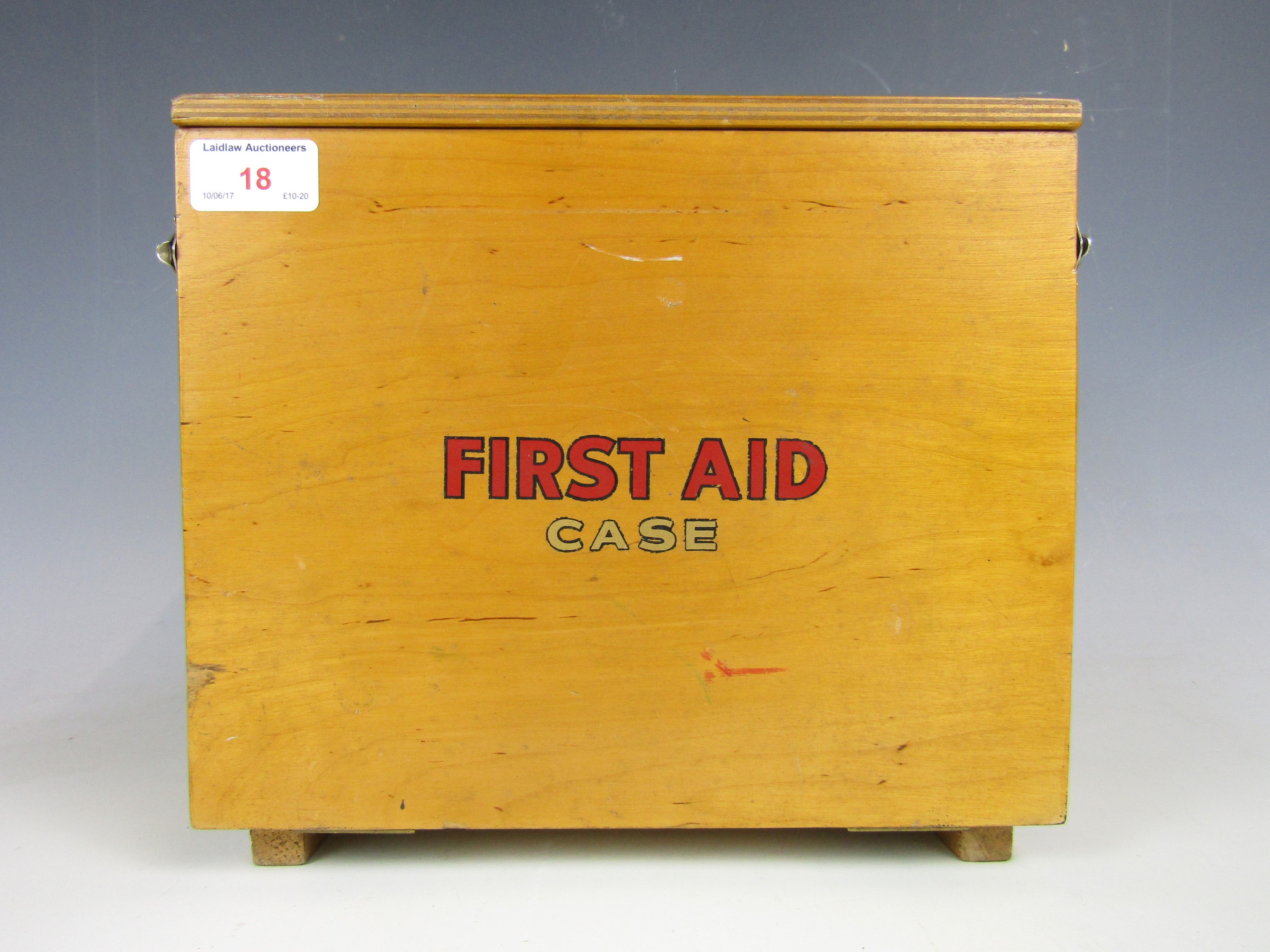 A 1950's First Aid box with contents including printed triangular bandages