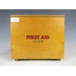 A 1950's First Aid box with contents including printed triangular bandages