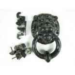 A vintage cast metal door knocker in the form of a lion's mask