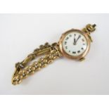 A 1920s lady's 9ct gold cased Swiss made wristwatch, with white enamelled face and Roman numerals,