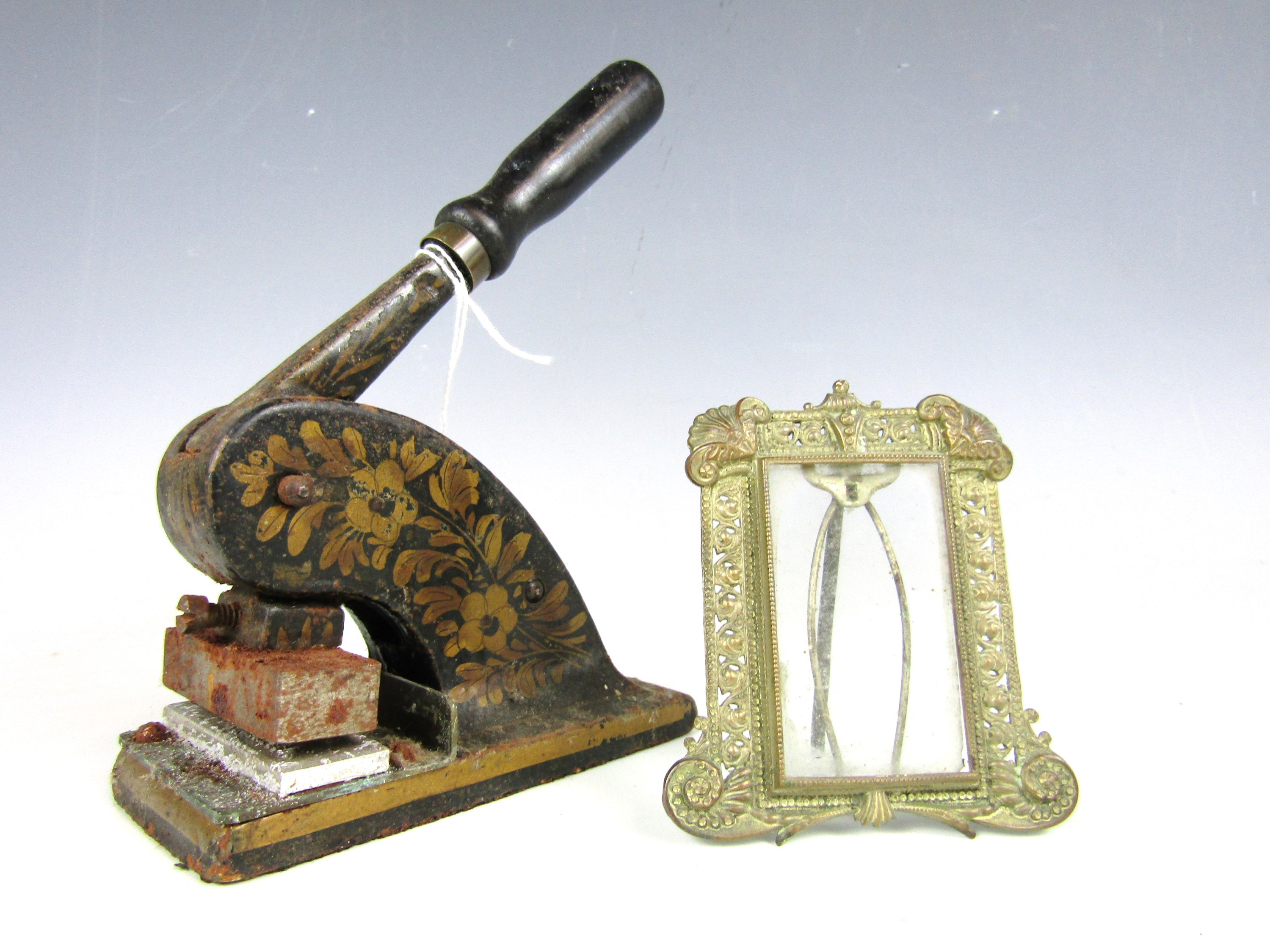 A Victorian letterhead blind embossing press together with a small metal photograph frame