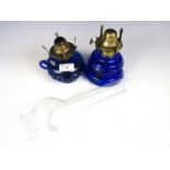 A pair of Victorian oil lamps with cobalt blue glass reservoirs