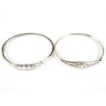 A contemporary Celtic style white metal hinged bangle set with a single paste brilliant, together