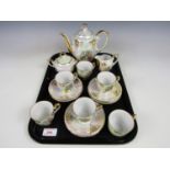 A vintage continental lustre porcelain coffee set transfer decorated with romantic vignettes