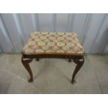 A vintage upholstered mahogany stool