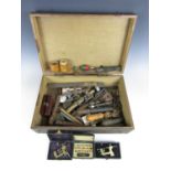 A wooden box containing vintage watchmakers' tools etc.