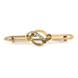 An Edwardian split seed pearl and yellow metal bar brooch, the open-faced bar being surmounted by an