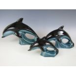 Three Poole Pottery dolphin figurines