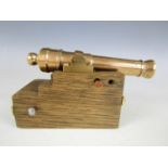 A brass model cannon on an oak sled, the barrel 14.5 cm