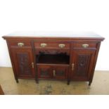 A late Victorian carved walnut sideboard