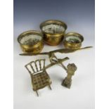 Vintage brassware including three graded cachepots, a brass model of an eagle, and a novelty brass