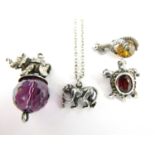 Novelty white metal fobs and brooches, including an elephant balancing on an amethyst 'ball', a