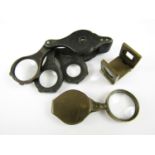 A 19th Century horn folding loupe, together with a brass 'thread counting' loupe, and one other