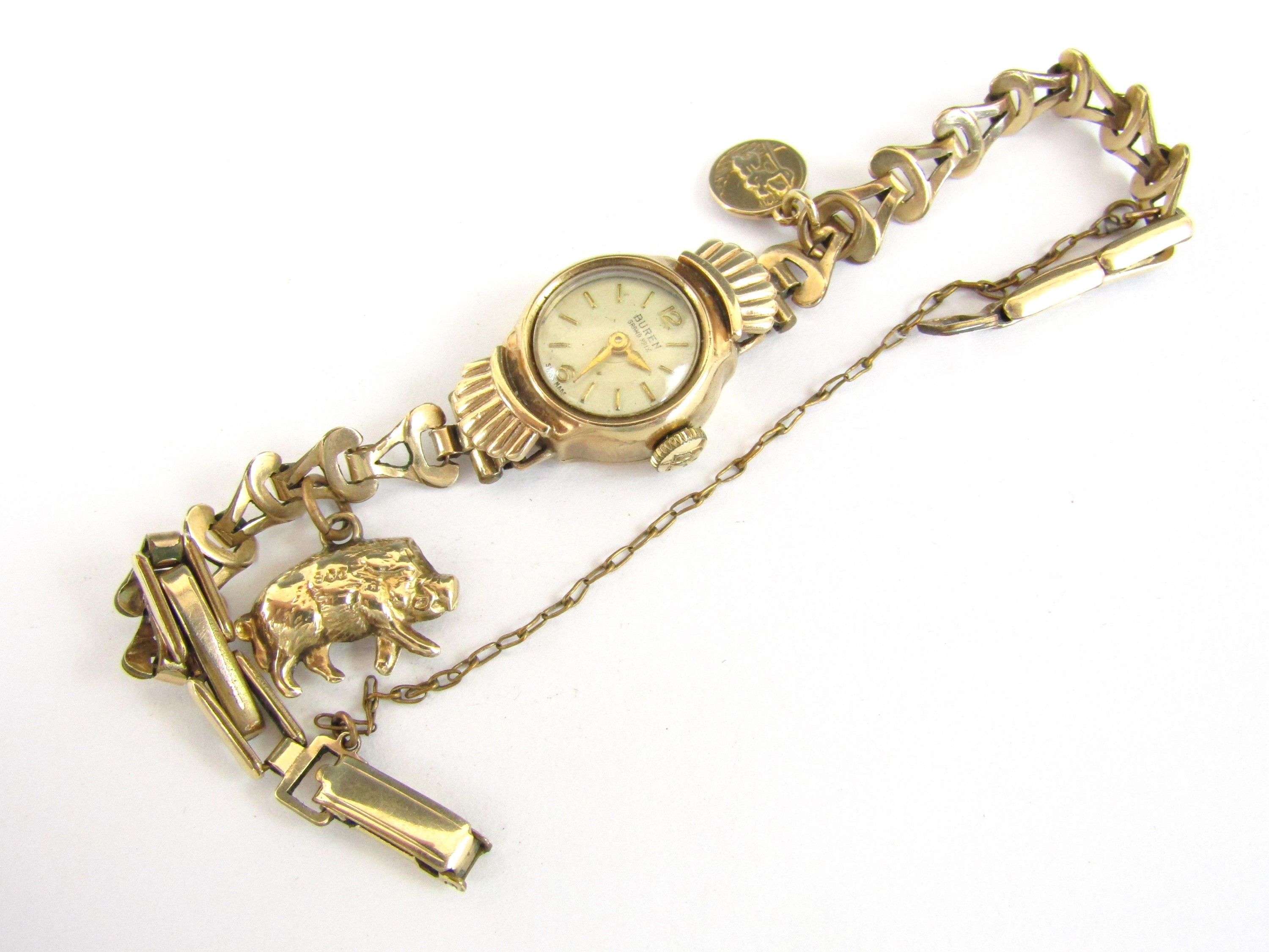 A lady's vintage Buren Grand Prix 9ct gold cased wrist watch, on a rolled gold bracelet strap,