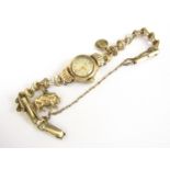 A lady's vintage Buren Grand Prix 9ct gold cased wrist watch, on a rolled gold bracelet strap,