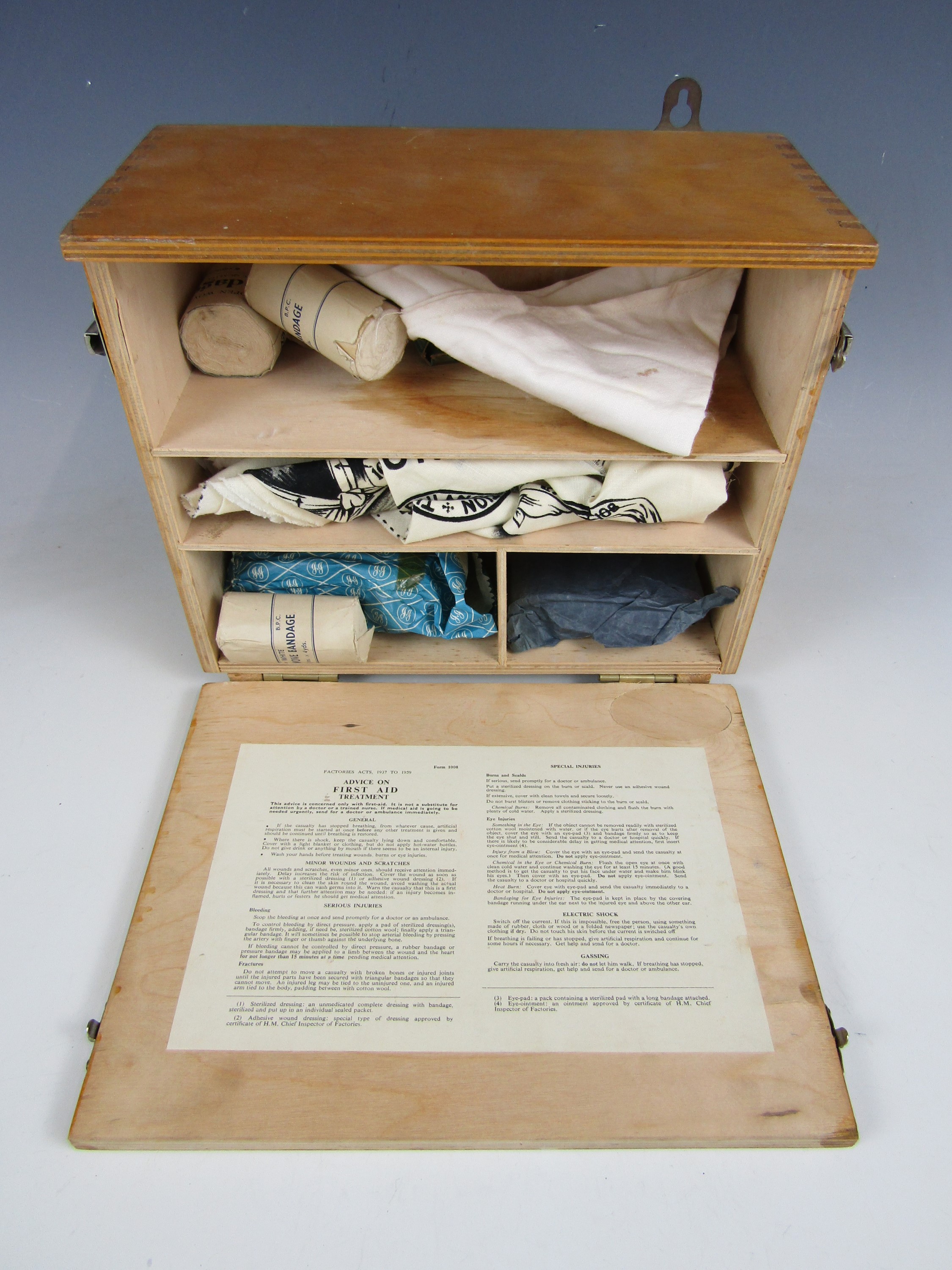 A 1950's First Aid box with contents including printed triangular bandages - Image 2 of 2