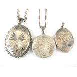 Two vintage silver pendant lockets on neck chains, together with one other similar in white metal,