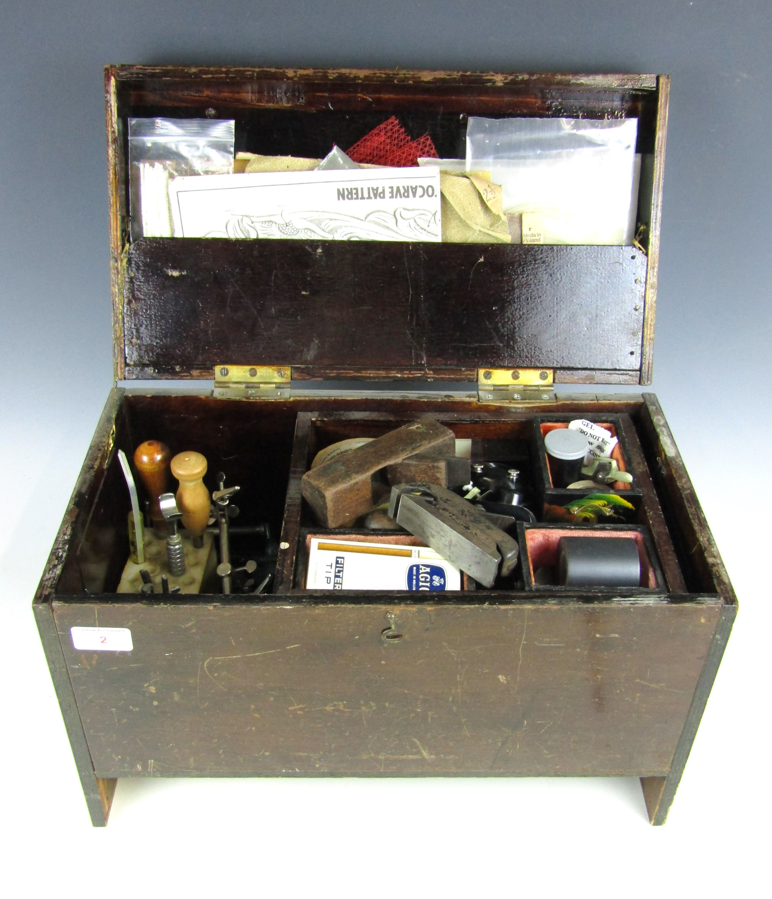 A vintage wooden case containing a large quantity of leather working and other tools etc.