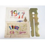 Sundry militaria including two silk postcards, a button stick, an RAF sweetheart brooch and a