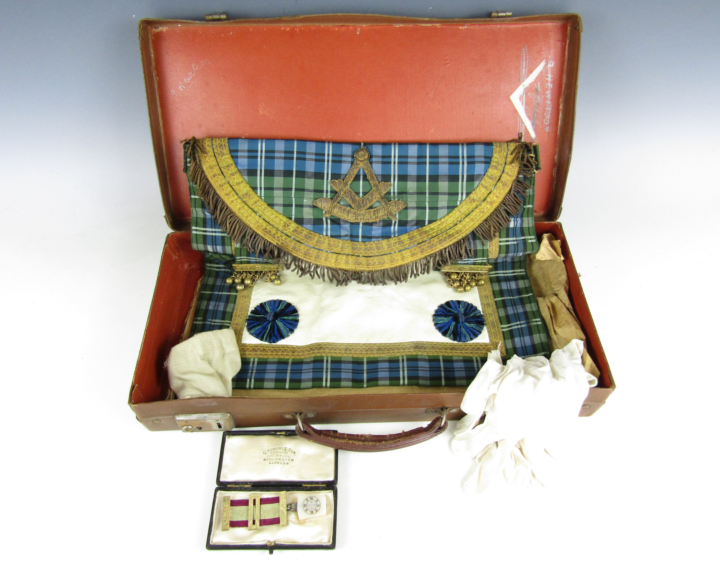 A vintage Masonic case containing a medallion and regalia