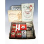 A vintage tin containing a large quantity of vintage cigarette cards