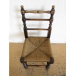 A vintage child's string seated oak chair