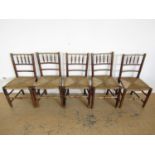 Five George III country dining chairs with rush seats (one a/f)