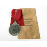 A German Third Reich Eastern Front Medal and envelope