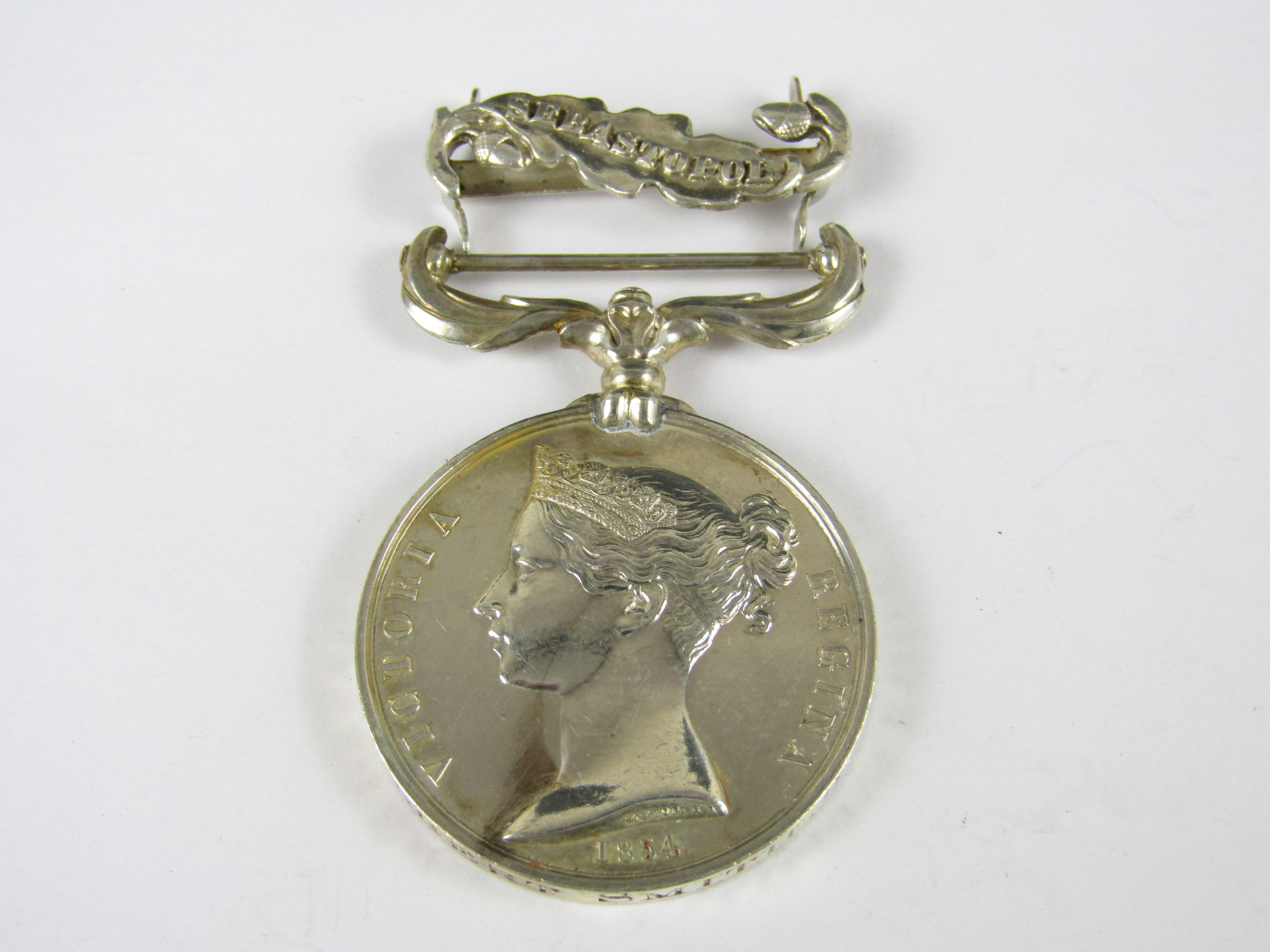 A Crimea Medal with loose Sebastopol clasp engraved to PRIE Gilbert Smith, 9th Foot