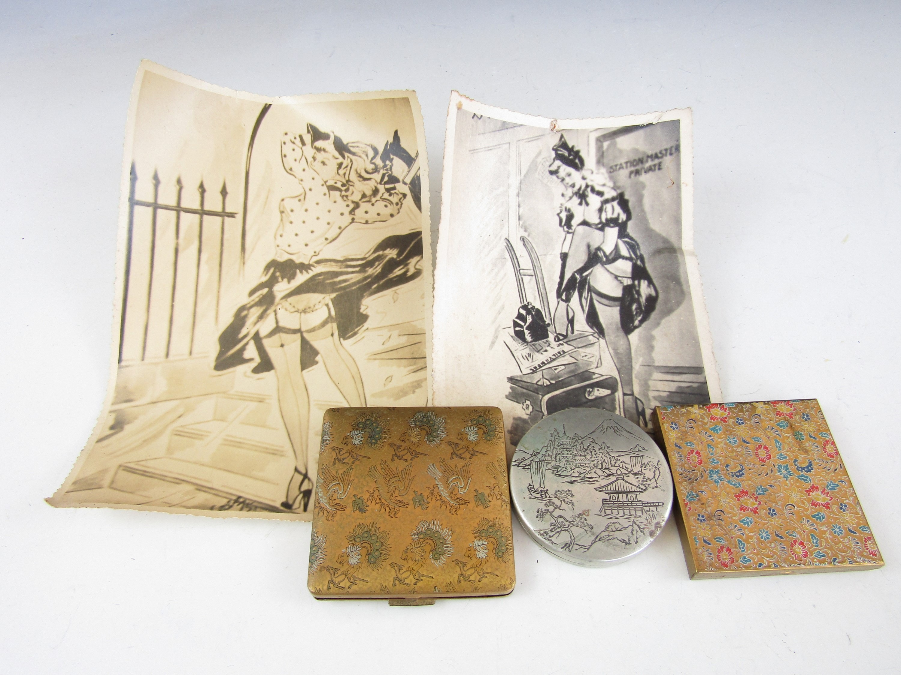 A Vanity Fair compact together with one other, a Japanese pocket mirror and two 1940's cartoon