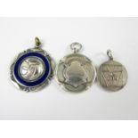 A George V silver fob medallion, together with a white metal fob medallion, (tests as silver), and