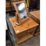 A contemporary pine bedside cabinet together with a small pine mirror