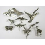 Vintage silver and white metal novelty brooches, including a violin, a fairy, a hat, and a flying