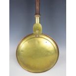 A 19th century copper and brass bed warming pan