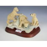 A 1986 WWF figurine depicting three polar bear cubs