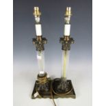 A pair of brass mounted cut glass columnar table lamps and three shades